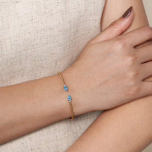 GABRIEL & CO 14K WHITE AND YELLOW GOLD BUJUKAN OPEN CUFF BRACELET WITH PEAR SHAPED BLUE TOPAZ